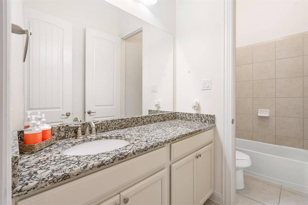 Additional secondary bedroom offers a vaulted ceiling and a serene atmosphere.