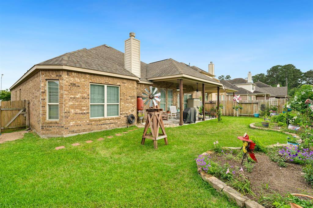 Fully fenced yard provides privacy, making it ideal for outdoor activities and relaxation.