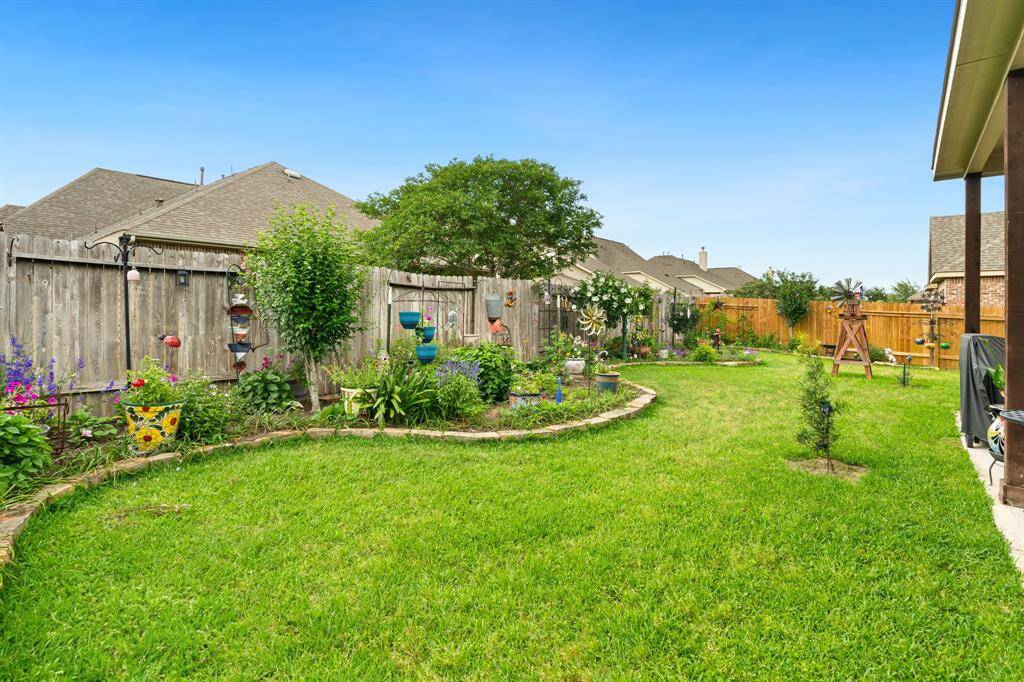 Beautifully maintained lawn with a landscaped flower bed accented by decorative edging.