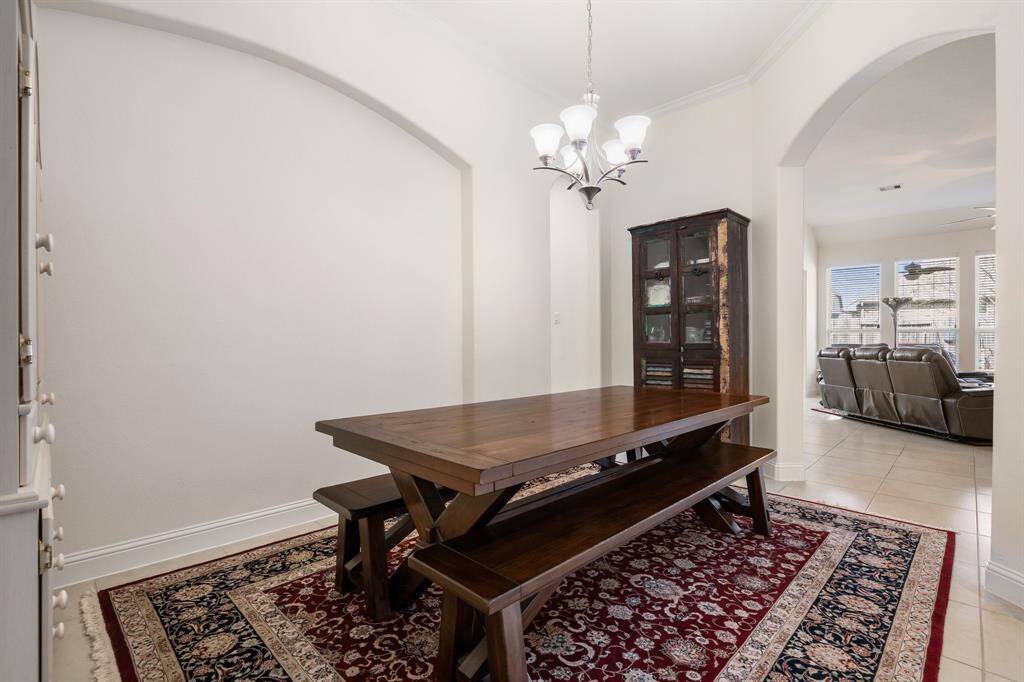 Welcoming brick-and-stone exterior home with a beautiful arched entryway.