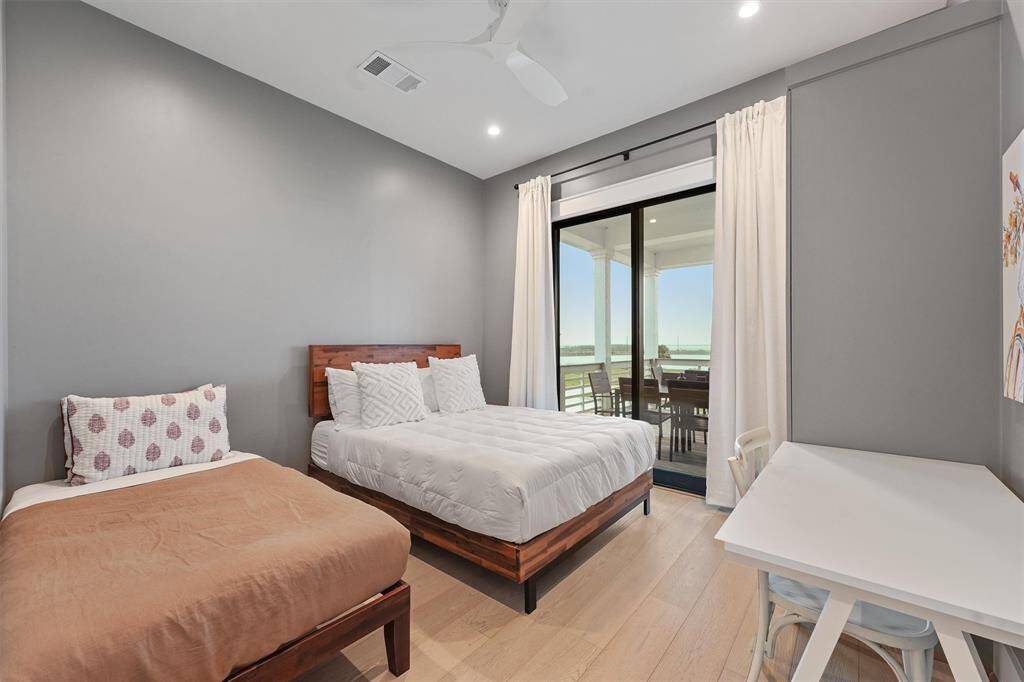 Cozy and stylish bedroom featuring warm wood tones, soft lighting, and private outdoor access for a peaceful retreat.