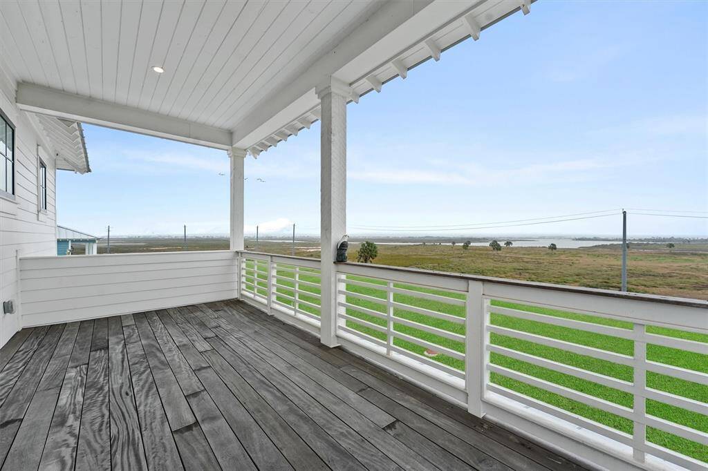 Expansive upper-level deck with breathtaking marsh and bay views, perfect for soaking in the coastal serenity.