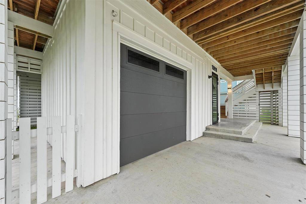 Covered garage entry with a sleek garage door