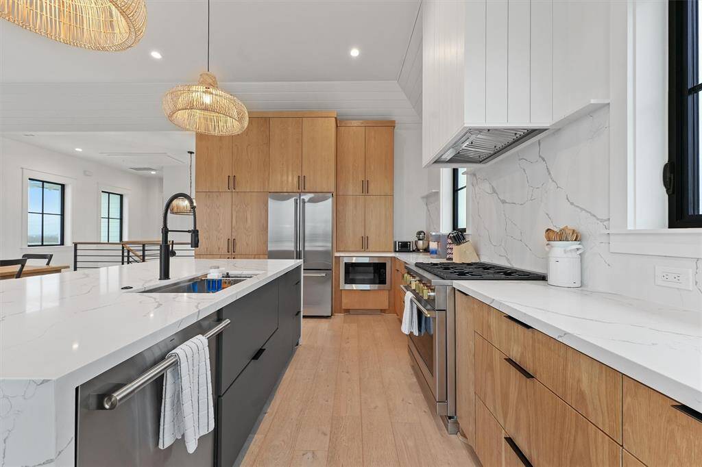A chef’s dream kitchen with high-end appliances, ample storage, and a spacious island with seating.