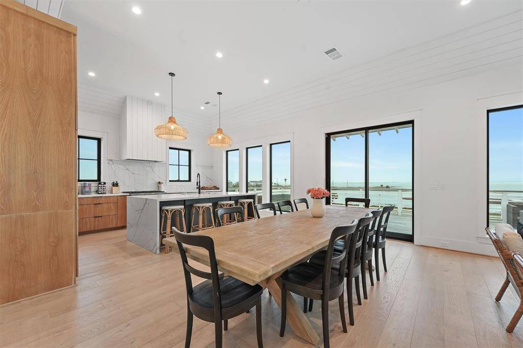Expansive dining area with panoramic bay views, perfect for gathering and entertaining.