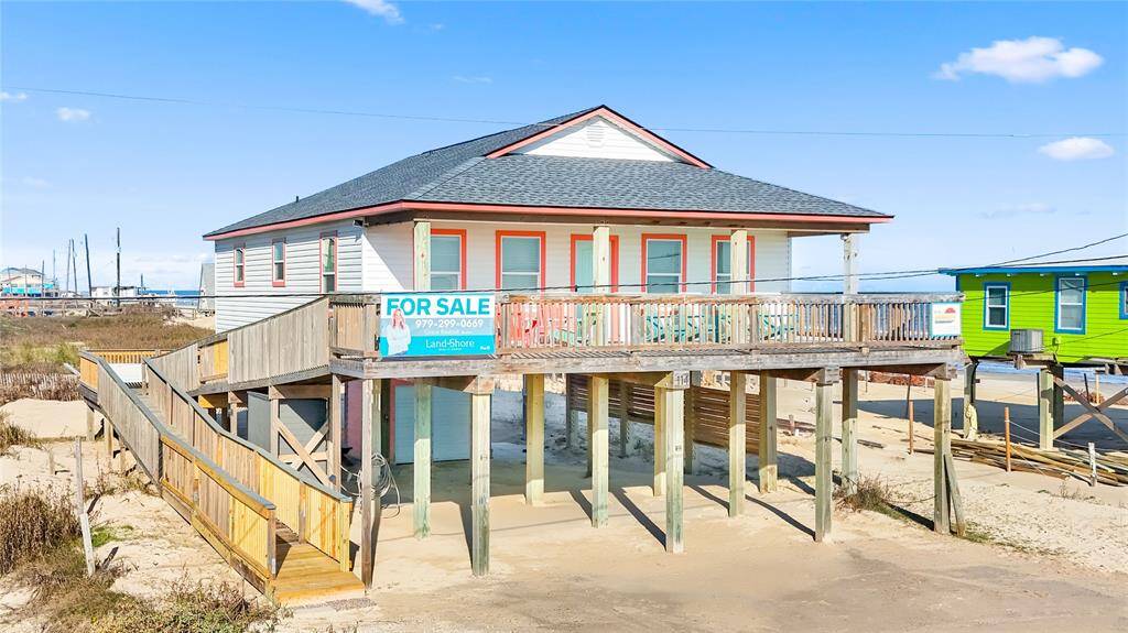 Steps away from the beach with two decks, ramp, golf cart garage, storage shed, outdoor shower, and incredible water views!