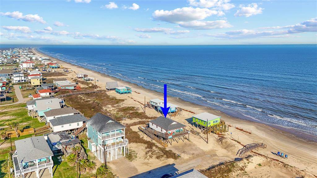 Steps away from the beach with two decks, ramp, golf cart garage, storage shed, outdoor shower, and incredible water views!
