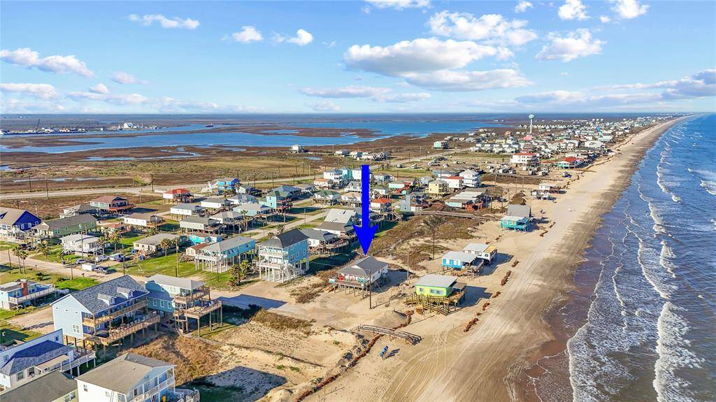 Steps away from the beach with two decks, ramp, golf cart garage, storage shed, outdoor shower, and incredible water views!