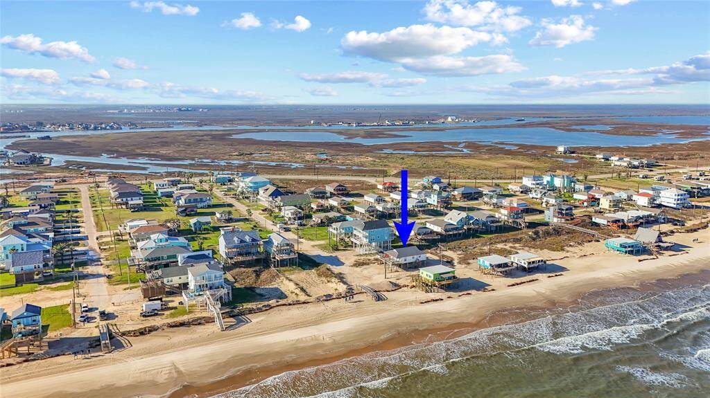 Steps away from the beach with two decks, ramp, golf cart garage, storage shed, outdoor shower, and incredible water views!
