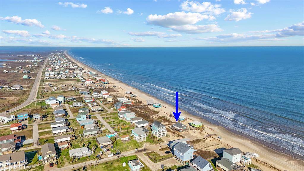 Steps away from the beach with two decks, ramp, golf cart garage, storage shed, outdoor shower, and incredible water views!