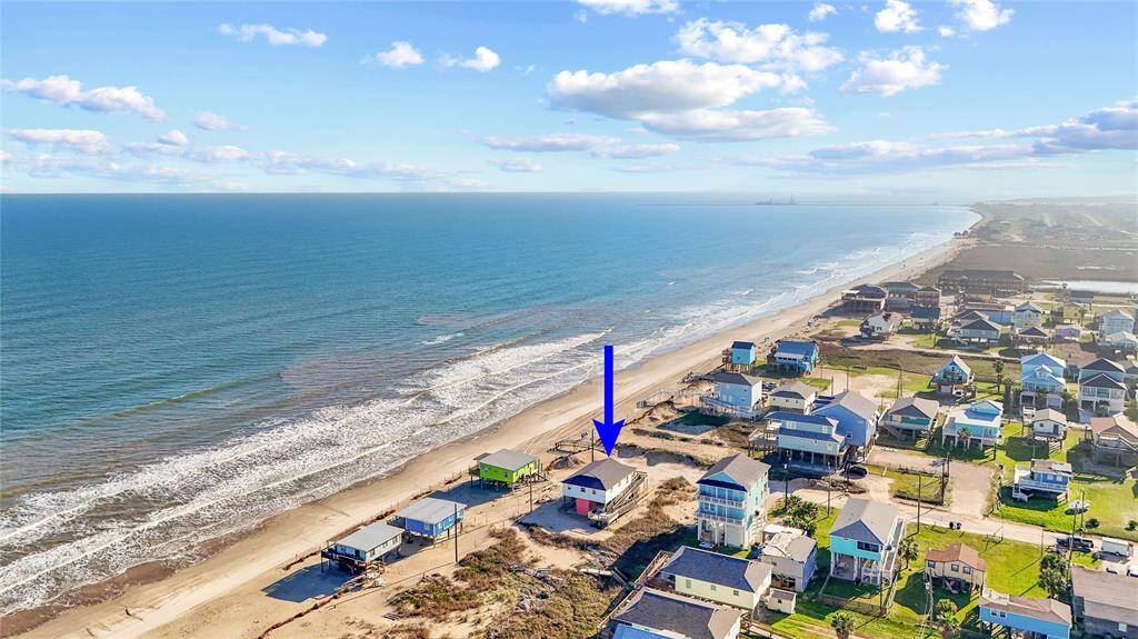 Steps away from the beach with two decks, ramp, golf cart garage, storage shed, outdoor shower, and incredible water views!