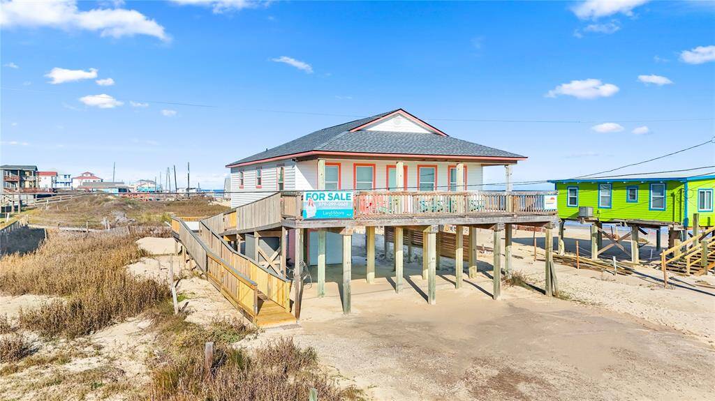 Steps away from the beach with two decks, ramp, golf cart garage, storage shed, outdoor shower, and incredible water views!