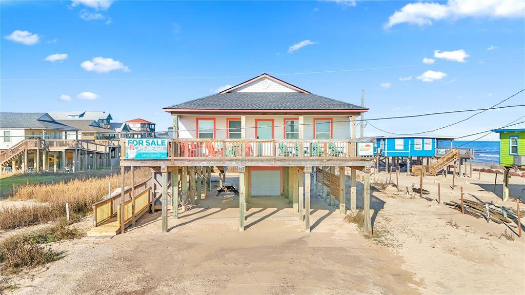 Steps away from the beach with two decks, ramp, golf cart garage, storage shed, outdoor shower, and incredible water views!