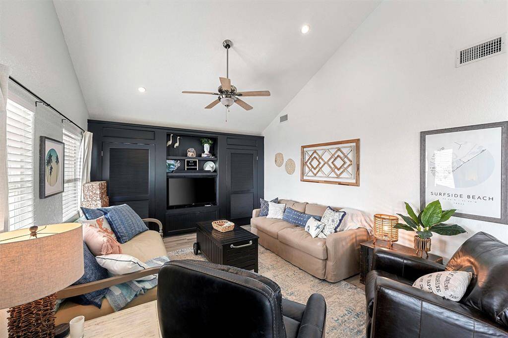 Vaulted ceilings, gorgeous built-in storage, open concept, and water views.