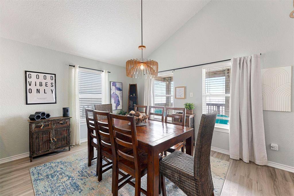 Vaulted ceilings, custom light fixture, open concept, and water views.