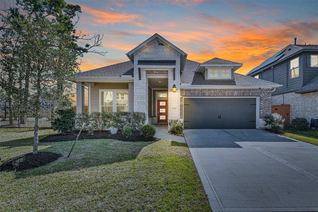 Beautiful Trendmaker home with stone and front porch elevation