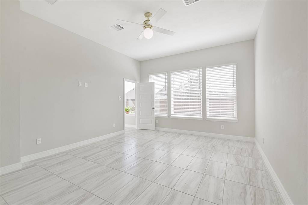 Large master bedroom with tile floors.