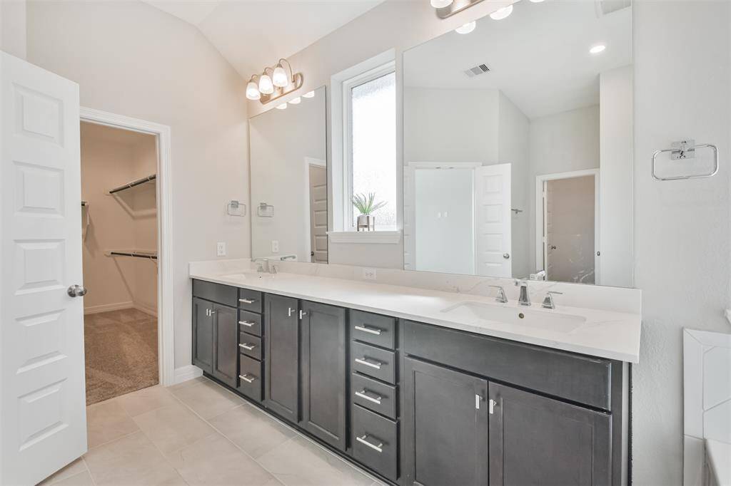 Double sinks in master bath and tons of cabinets.