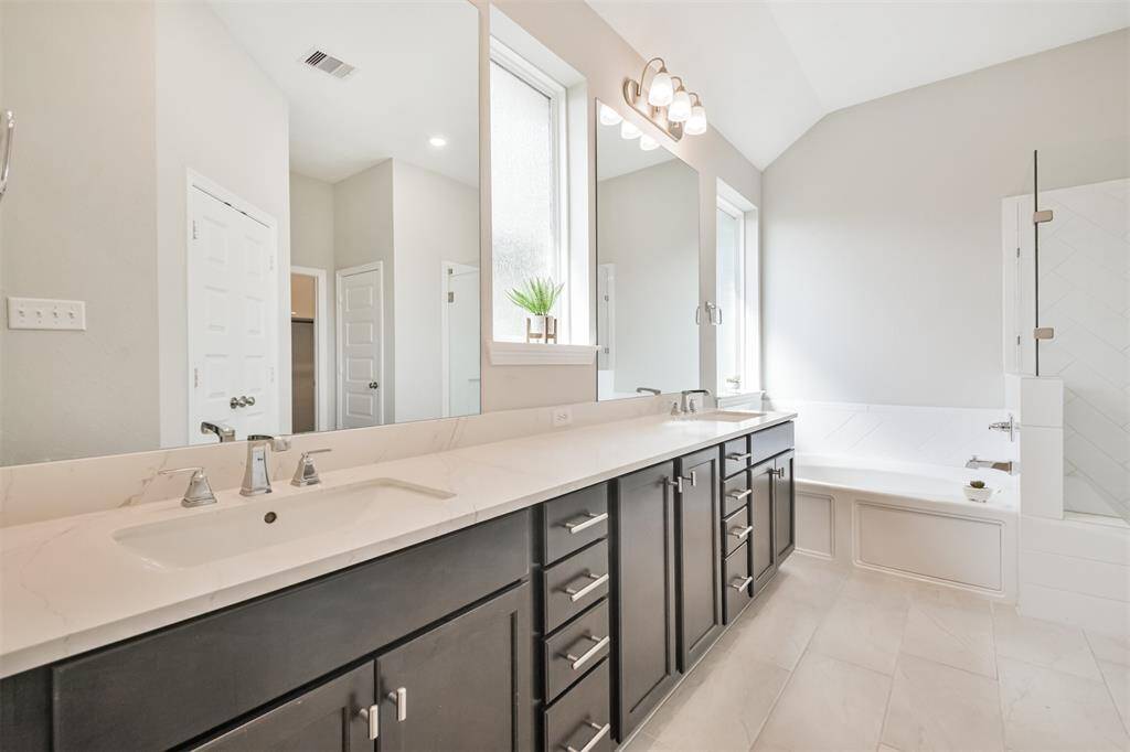Quartz counter tops, hardware on drawers and wait till you see the close up of the large shower.