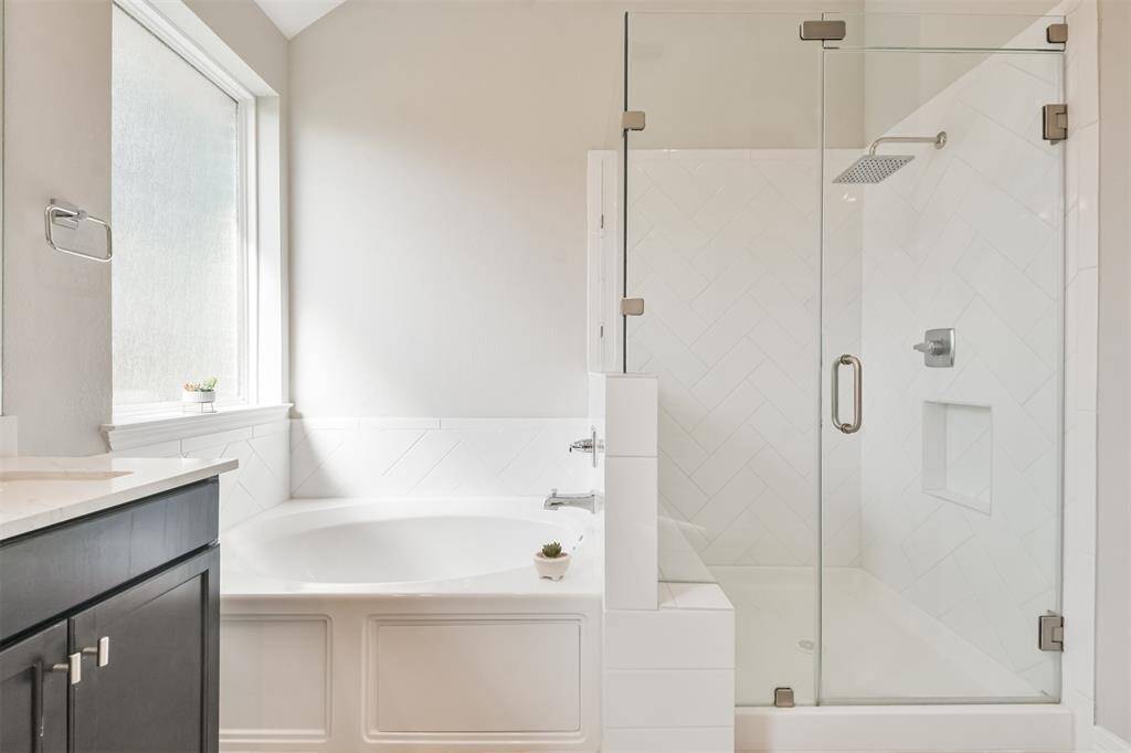 Large shower with seating and place for your products to go.