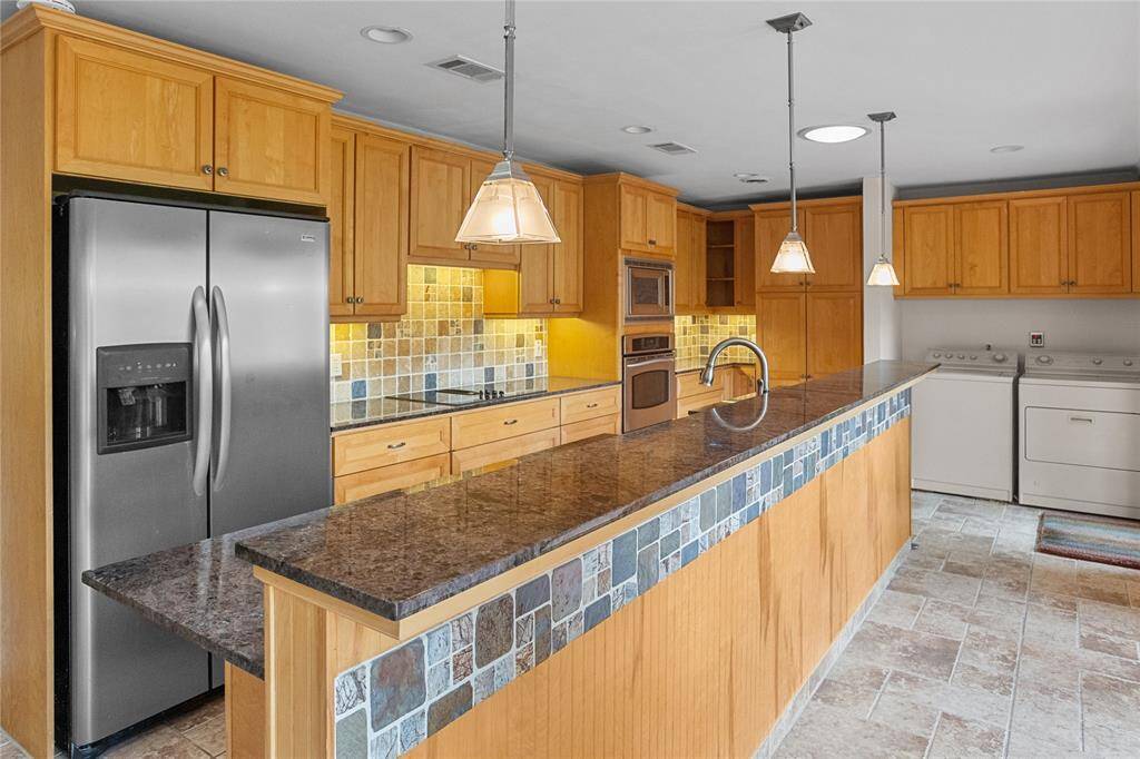 Remodeled kitchen with stainless steel appliances, granite countertops, breakfast bar and much more!
