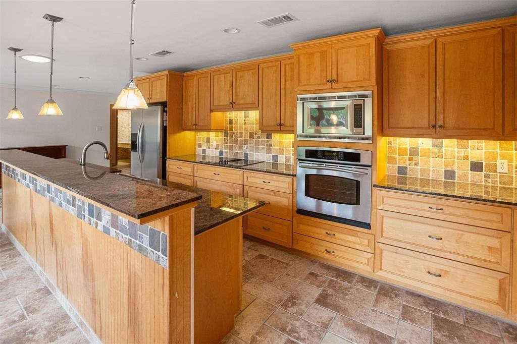 Custom cabinets with lots of pot drawers on lowers.