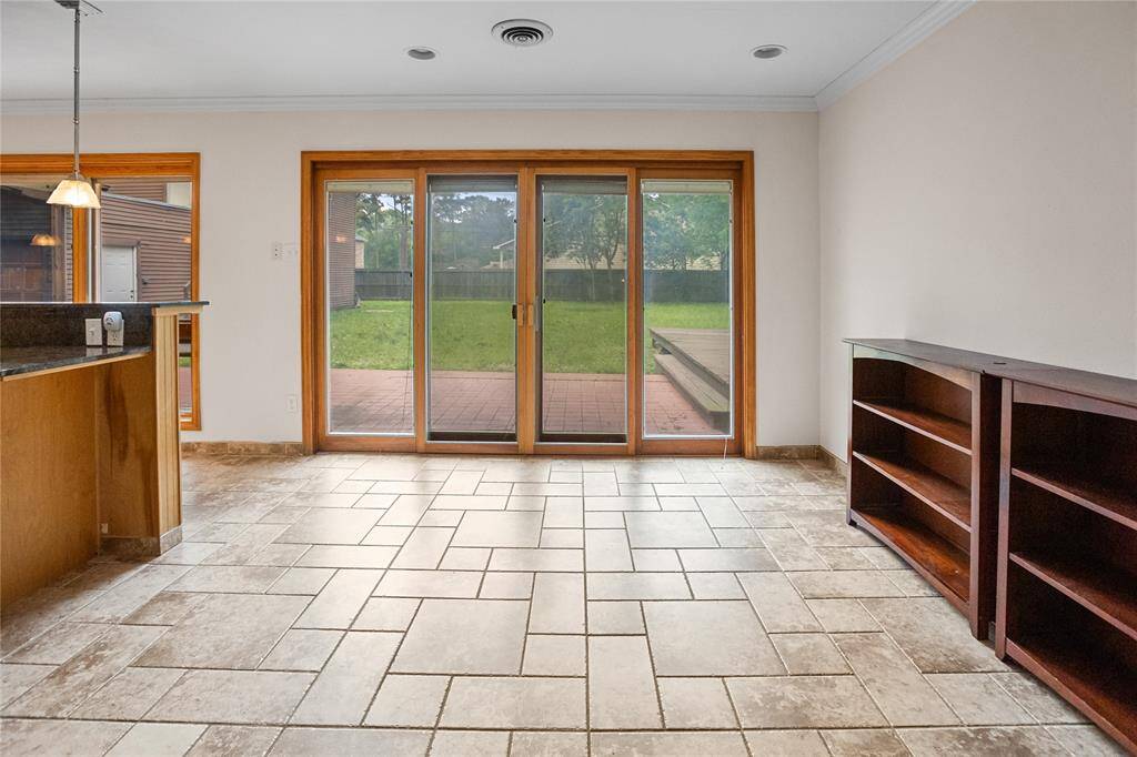 Doors off breakfast area opening out to the backyard patio deck.