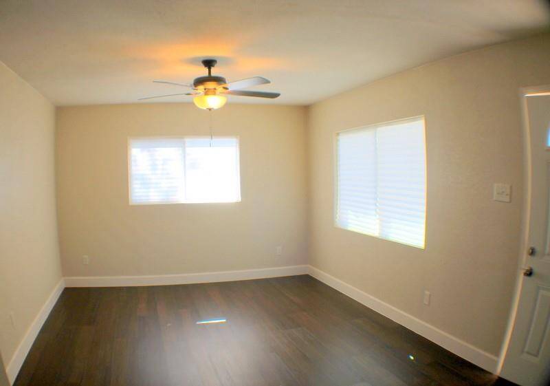 Freshly painted, new light/ceiling fan fixture, new wood look vinyl plank flooring.