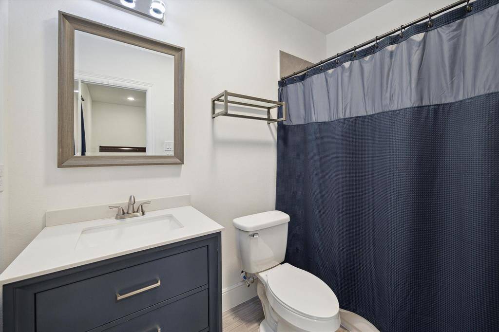 private bathroom that belongs to the secondary bedroom on 3rd floor. quartz tops, porcelain floors.