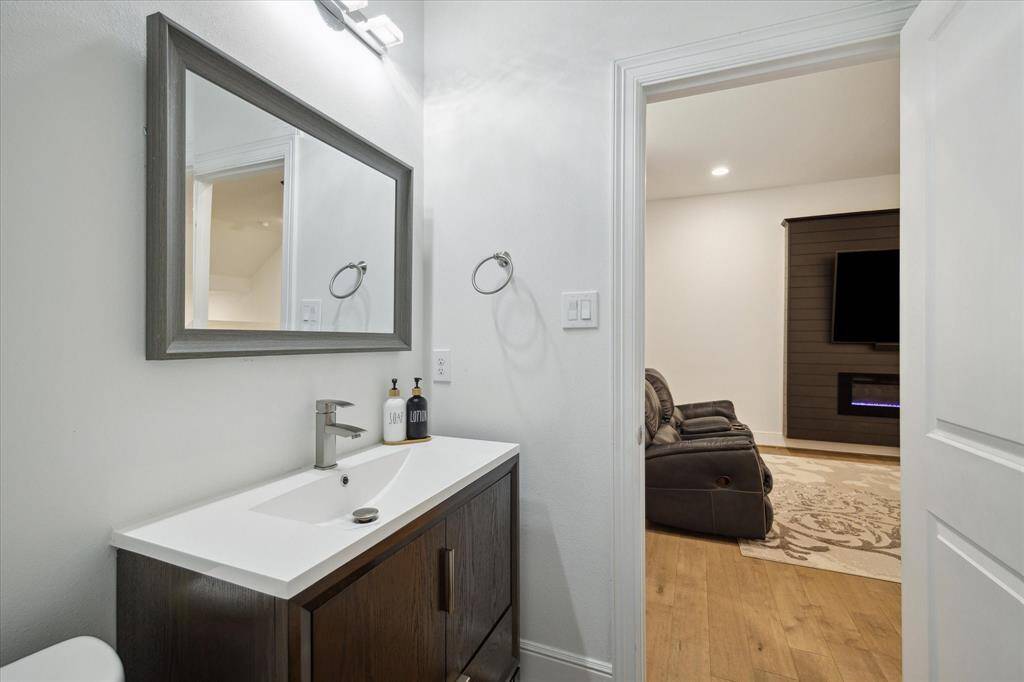 powder bath just off the living space. quartz countertop. porcelain tile floor.