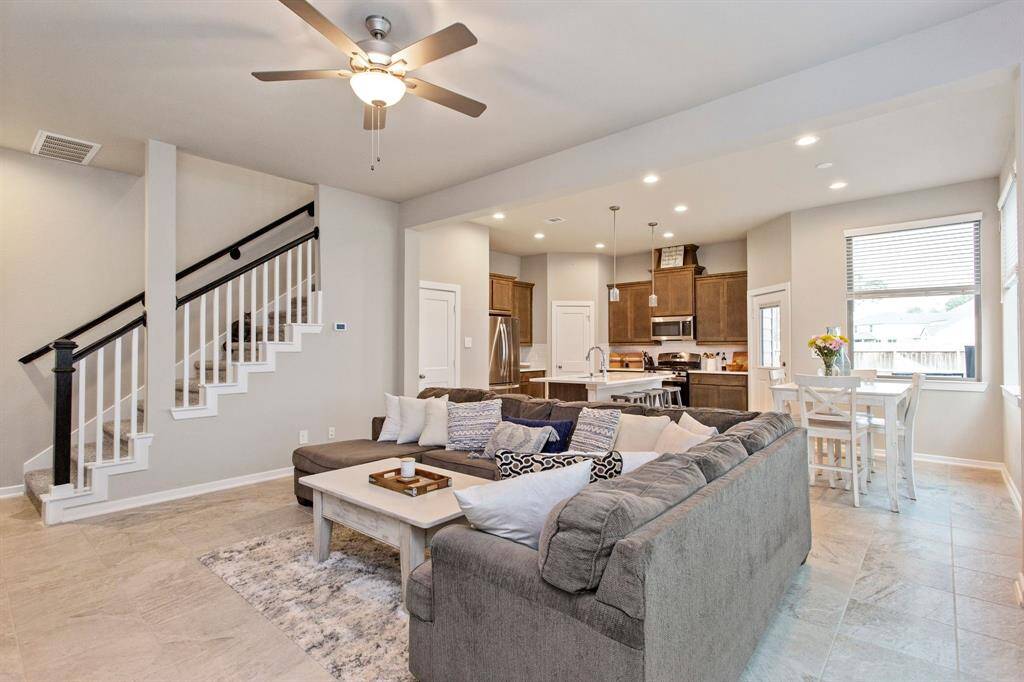 View of the open concept living, kitchen and dining areas as you enter the front door of the home.