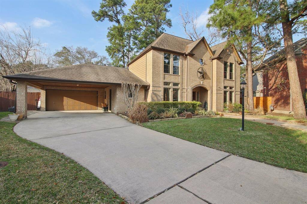 Wide driveway. 2 car garage and a 2 car porte cochere with door to access home.