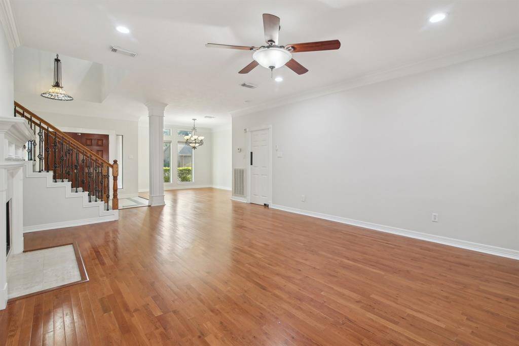 Large family room with columns and updated fixtures.