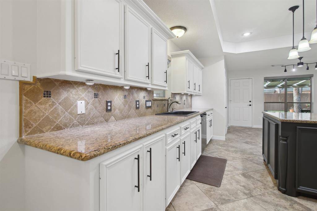 Granite countertops and elegant hardware on cabinets.