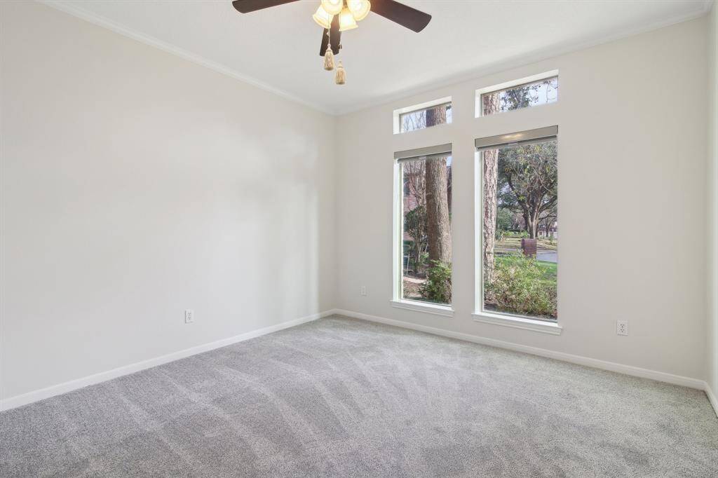 another photo of guest bedroom and large windows.