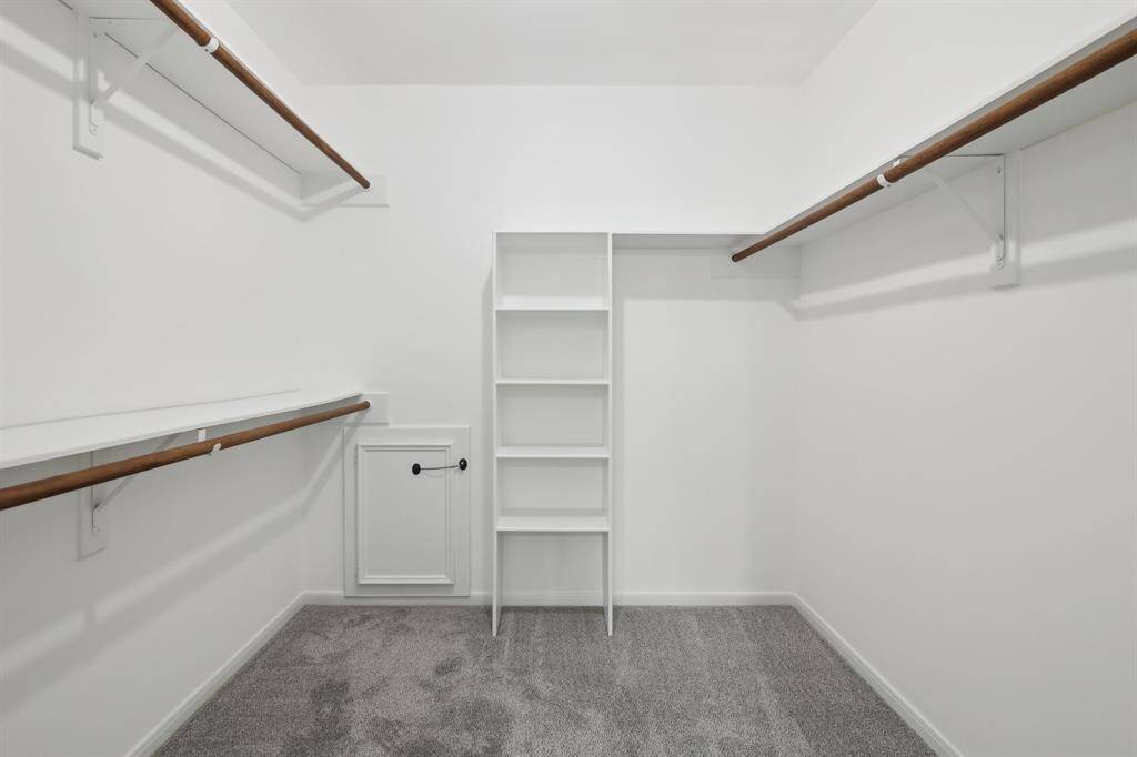 Large walk in closet with shelves