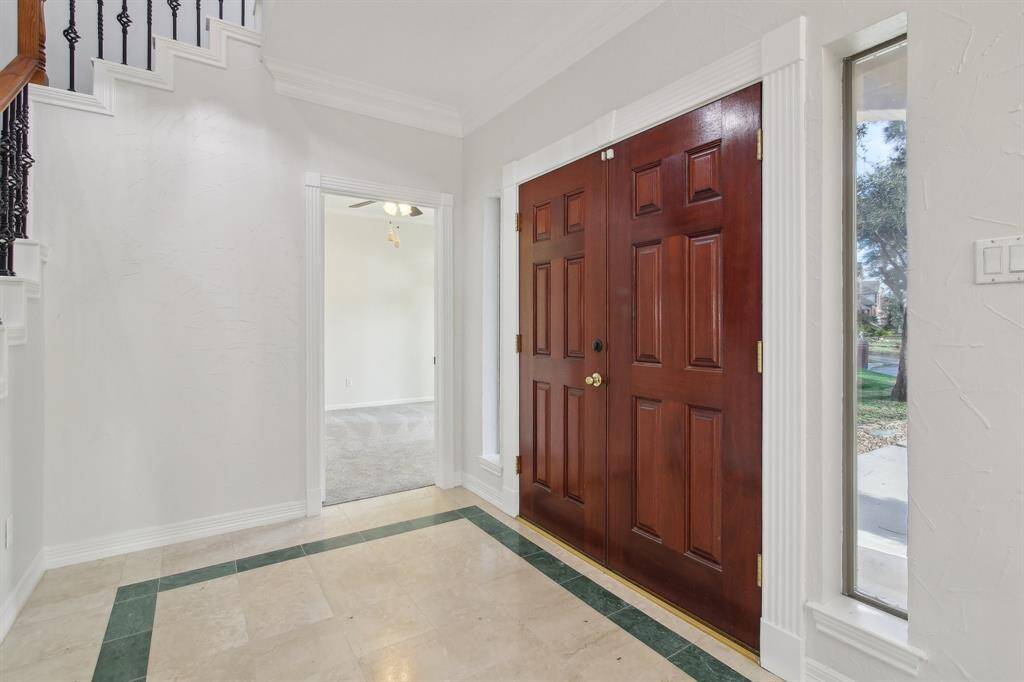 Large foyer with beautiful wood double entry.