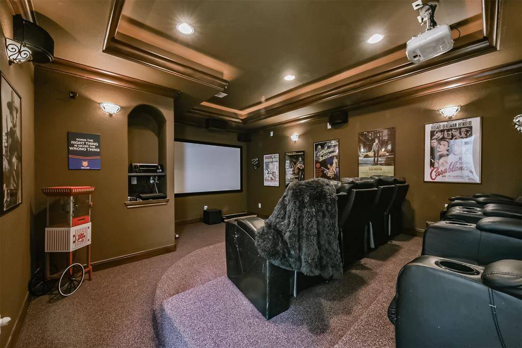 This media room will blow you away. Can come fully furnished included chairs, the art you see on walls and popcorn maker.