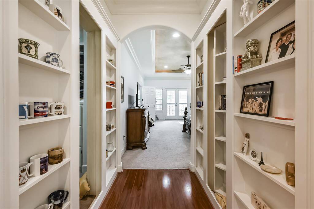Secret door in shelves leads to his and hers closets.