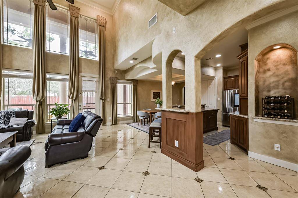 Stunning living room with custom drapes, beautiful colors and architecture.
