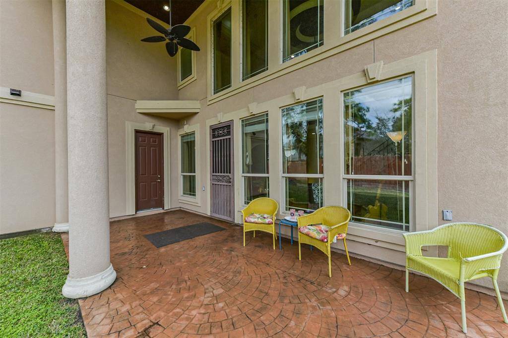 Large covered patio with 2 story ceilings and additional half bath on patio.