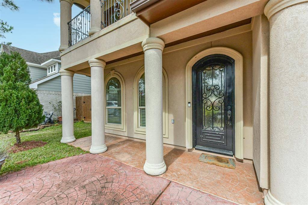 Covered front patio with extra space to keep your plants.