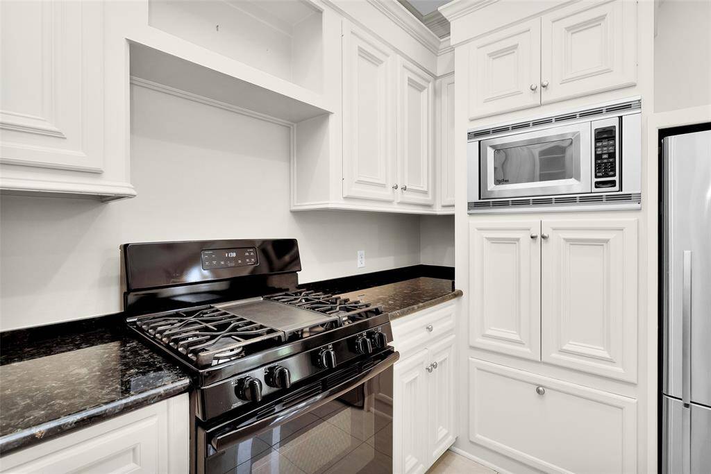 Granite Counters and Under-mount Sink with Goose-Neck Faucet, Trash Can Pull-Out Drawer.