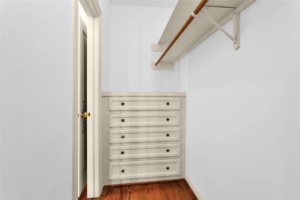 Primary Bedroom Closet with Built-in Dresser.