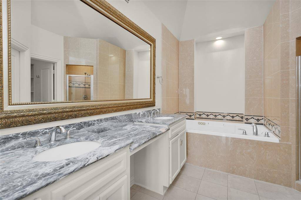 Primary Bath with Double Vanities, Jetted Soaking Tub and Separate Shower.