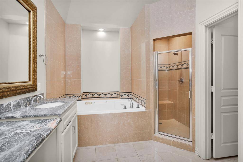 Primary Bath with Double Vanities, Jetted Soaking Tub and Separate Shower.