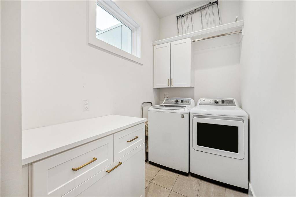 Laundry room has lots of storage and a side by side W/D
