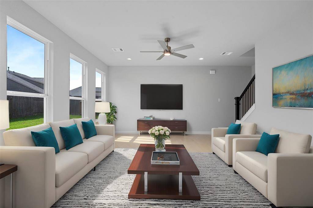 Gather the family and guests together in your lovely family room! Featuring high ceilings, recessed lighting, ceiling fan, custom paint, gorgeous floors and large windows that provide plenty of natural lighting throughout the day.