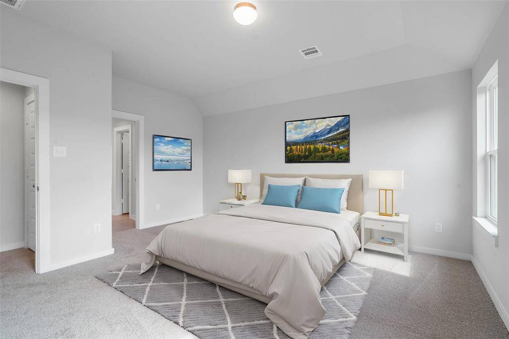 Come and unwind after a long day in this magnificent primary suite! This spacious room features plush carpet, warm paint, high ceilings and large windows.