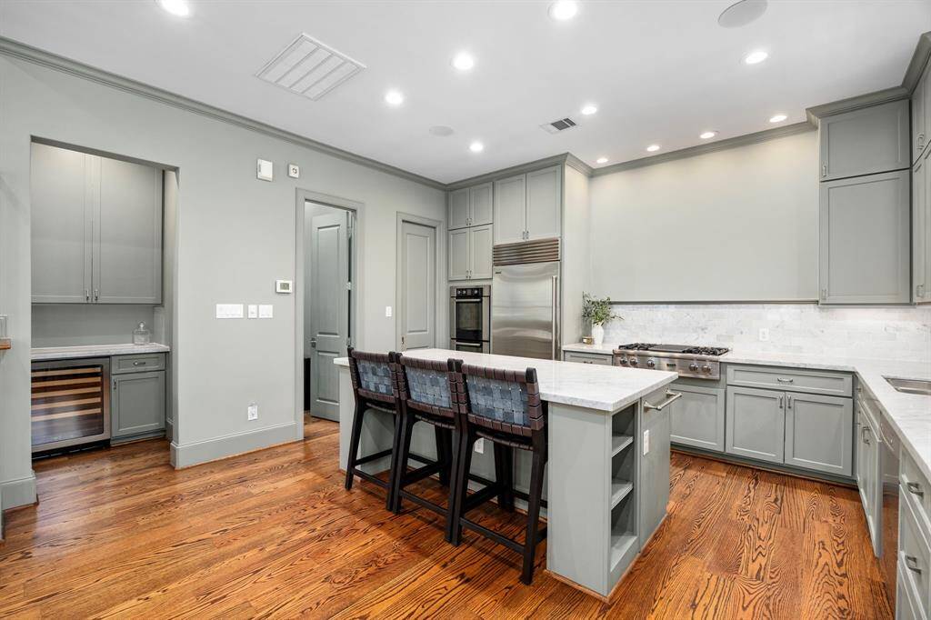 Dry bar, powder bath and pantry are all located off the kitchen.